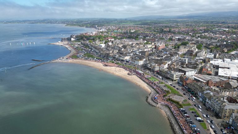 The Coronation Carnival Parade makes its way along the promenade during celebrations for the Big Lunch on the prom, in Morecambe