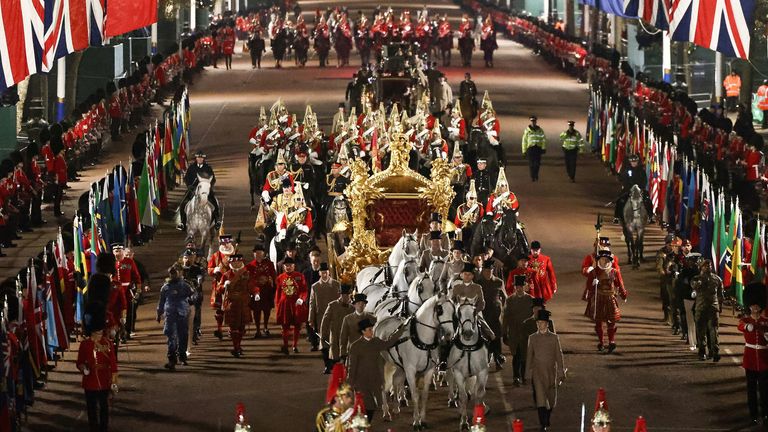 The Gold State Coach is ridden alongside members of the military during a full overnight dress rehearsal of the coronation ceremony in central London