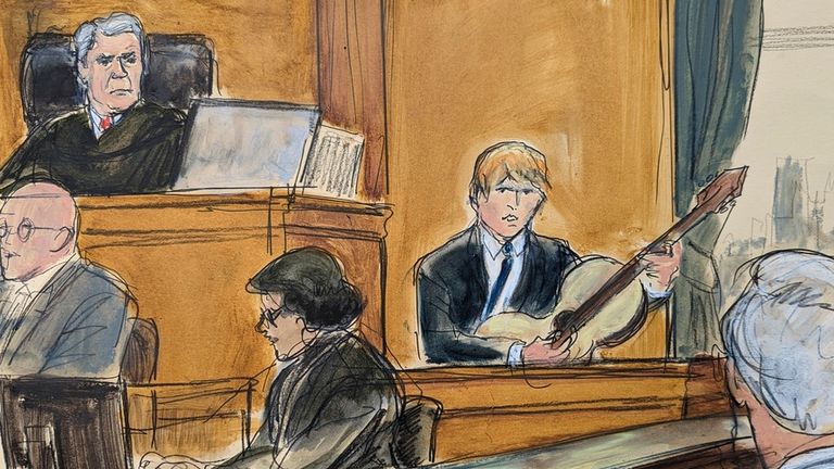 Ed Sheeran plays his guitar on the witness stand during his testimony with Judge Louis Stanton presiding, Monday, May 1, 2023 in Manhattan federal court. Sheeran continued testifying, Monday, to deny allegations that his hit song "Thinking Out Loud" ripped off Marvin Gaye&#39;s soul classic "Let&#39;s Get It On." (Elizabeth Williams via AP)