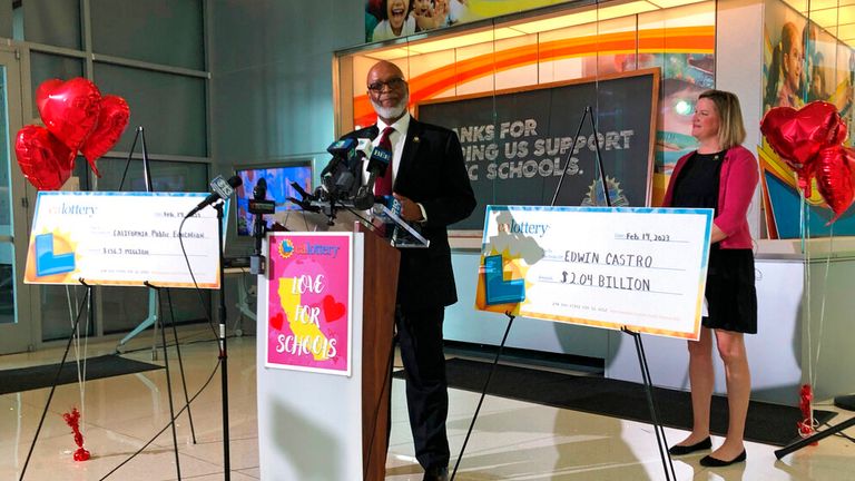 California Lottery director Alva Johnson announced Edwin Castro as the jackpot winner. Pic:AP