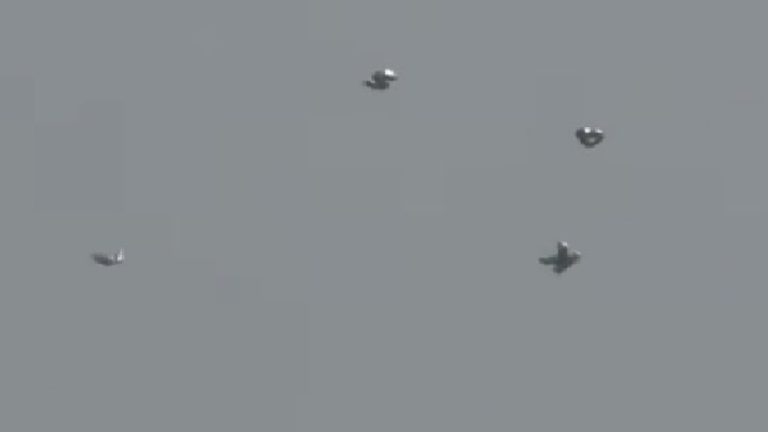 The footage of the balloons was caught on camera by London Planespotting, a group of planespotters who were filming from the end of the Gatwick Airport runway at around 1pm when they spotted the silver objects in the sky. MUST CREDIT: YouTube.com/LondonPlanespotting 