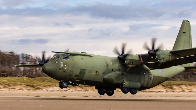 April 13 2021: A Royal Air Force Lockheed C-130J &#39;Super Hercules&#39; performing tactical landings and takeoffs from the public beach at Cefn Sidan Sands in West Wales.