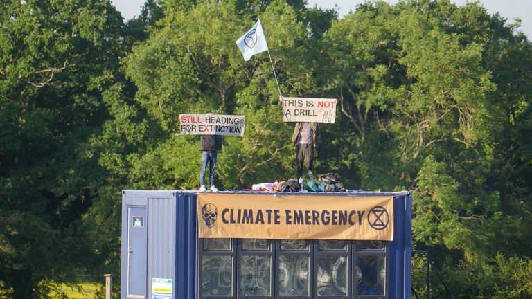 Extinction Rebellion activists hold banners as they protest at the Horse Hill oil field, part-owned by British energy company UK Oil & Gas, in Surrey, Britain, June 1, 2020. Steve Ringham/Jono/Extinction Rebellion South East/via REUTERS.  THIS IMAGE IS PROVIDED BY A THIRD PARTY.