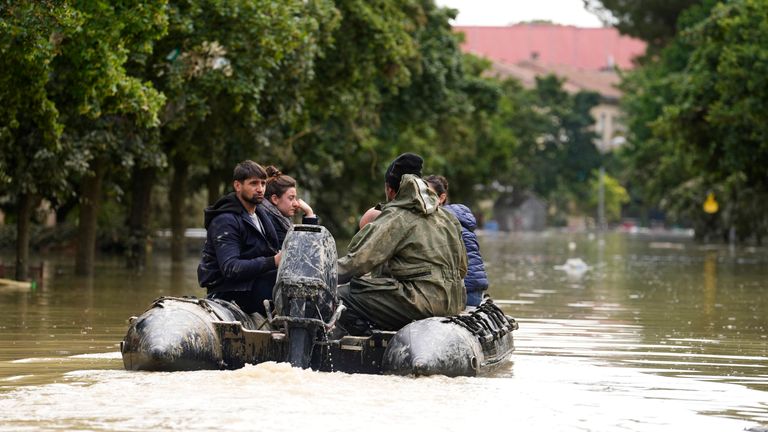 Rescuers use a dinghy to evacuate people in Faenza, Italy
Pic:AP