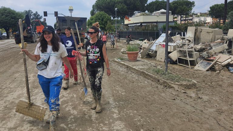 Volunteers help clearing the mud from a street in Forli, Italy, Sunday, May 21, 2023. Rescue crews are working to reach towns and villages in northern Italy that were cut off from highways, electricity and cell phone service following heavy rains and flooding. Farmers are warning of “incalculable” losses and authorities have begun mapping out cleanup and reconstruction plans. Pic: AP