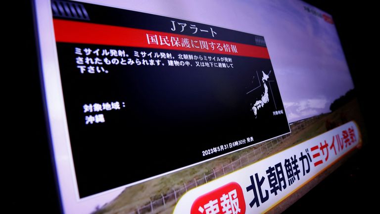 A TV screen displays a warning message called "J-alert" after the Japanese government issued an emergency warning for residents of the southern prefecture of Okinawa, saying a missile had been launched from North Korea, in Tokyo, Japan May 31, 2023. REUTERS/Issei Kato