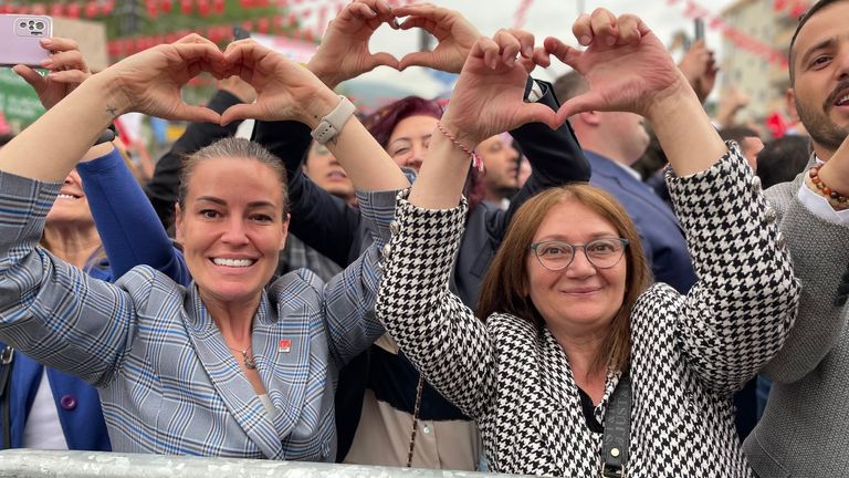 Supporters of Mr Kilicdaroglu make his familiar sign - a heart shape made with his two hands