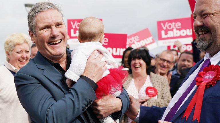 Labour leader Sir Keir Starmer holds five month old Hazel  as he joins party members in Chatham, Kent 