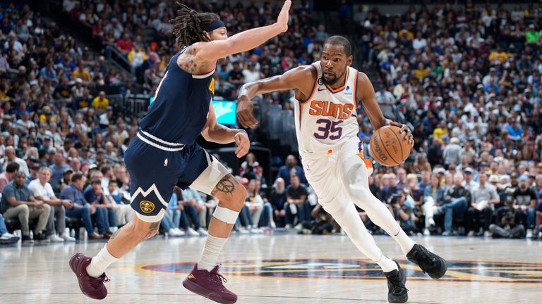 Phoenix Suns forward Kevin Durant, right, drives past Denver Nuggets forward Aaron Gordon in the second half of Game 2 of an NBA second-round playoff series Monday, May 1, 2023, in Denver. (AP Photo/David Zalubowski)