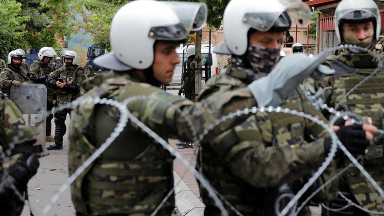 Polish Kosovo Force (KFOR) soldiers stand guard near a municipal office in Zvecan, Kosovo  