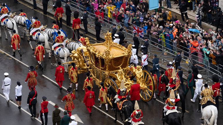 King Charles III and Queen Camilla are carried in the Gold State Coach, pulled by eight Windsor Greys                                                             