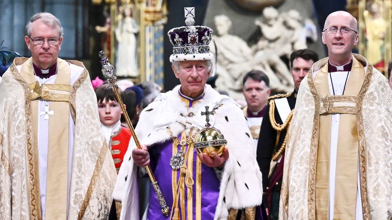 Britain&#39;s King Charles III wearing the Imperial state Crown and carrying the Sovereign&#39;s Orb and Sceptre leaves Westminster Abbey after coronation in central London Saturday, May 6, 2023. The set-piece coronation is the first in Britain in 70 years, and only the second in history to be televised. Charles will be the 40th reigning monarch to be crowned at the central London church since King William I in 1066. (Ben Stansall/POOL photo via AP)