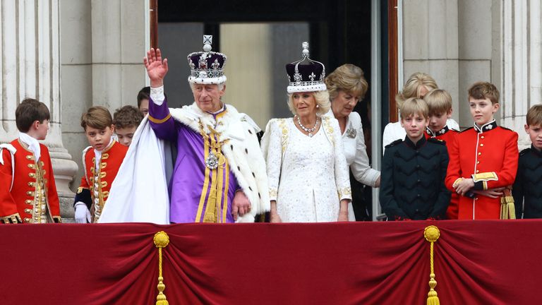  King Charles and Queen Camilla stand on the Buckingham Palace balcony following their coronation ceremony
