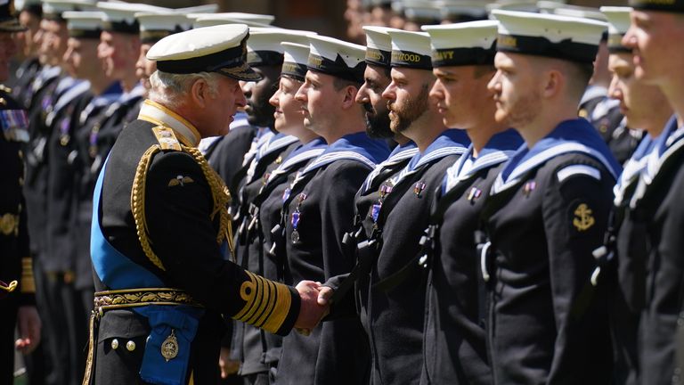 King Charles III presents the Royal Victorian Order to members of the Royal Navy