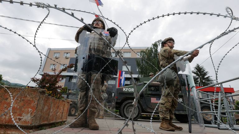 U.S. KFOR soldiers stand guard in front of the municipality office, in the town of Leposavic, Kosovo