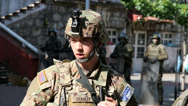 A U.S. soldier stands guard at a municipal office in Zvecan, Kosovo