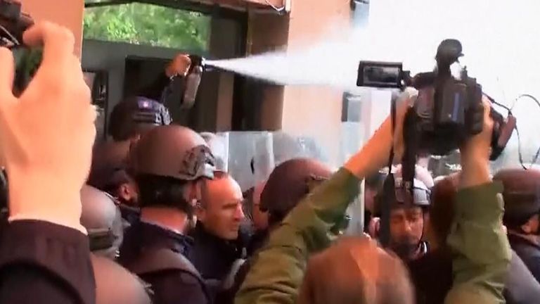Tear gas is fired from a government building in Kosovo
