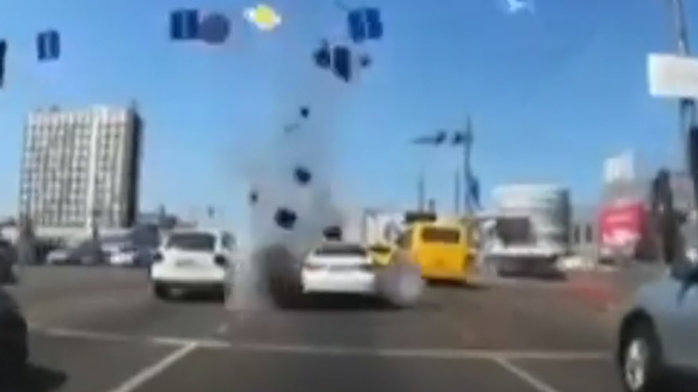  Dash cam footage shows moment rocket debris hit busy road in Kyiv.
