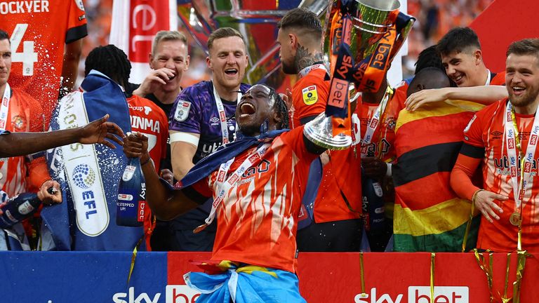 Soccer Football - Championship Play-Off Final - Coventry City v Luton Town - Wembley Stadium, London, Britain - May 27, 2023 Luton Town&#39;s Pelly-Ruddock Mpanzu celebrates with the trophy after winning the Championship Play-Off Final Action Images via Reuters/Matthew Childs EDITORIAL USE ONLY. No use with unauthorized audio, video, data, fixture lists, club/league logos or &#39;live&#39; services. Online in-match use limited to 75 images, no video emulation. No use in betting, games or single club /league