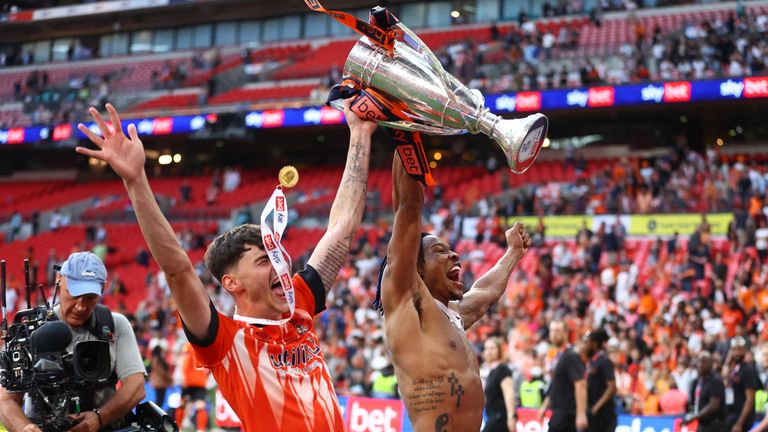 Soccer Football - Championship Play-Off Final - Coventry City v Luton Town - Wembley Stadium, London, Britain - May 27, 2023 Luton Town&#39;s Gabriel Osho and Elliot Thorpe celebrate with the trophy after winning the Championship Play-Off Final REUTERS/Carl Recine