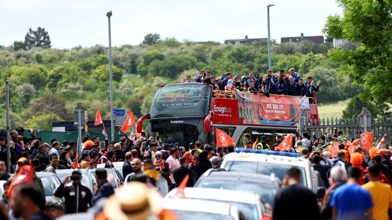 Luton Town players celebrate their promotion to the Premier League during an open top bus parade