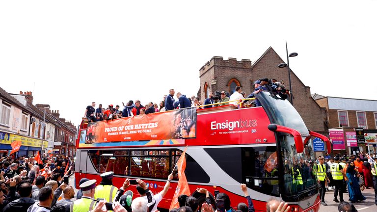Luton Town players celebrate their promotion to the Premier League during an open top bus parade 