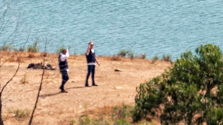 Officers of Portugal&#39;s investigative Judicial Police are seen at the site of a remote reservoir where a new search for the body of Madeleine McCann is set to take place, in Silves, Portugal, in this screen grab from a video, May 22, 2023. REUTERS/Luis Ferreira
