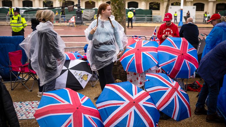 Royal fans wear ponchos as rain falls along the King&#39;s Coronation route at The Mall in London, Friday, May 5, 2023. The Coronation of King Charles III will take place at Westminster Abbey 
Pic:AP