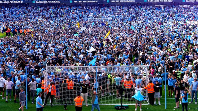 Manchester City fans invade the pitch