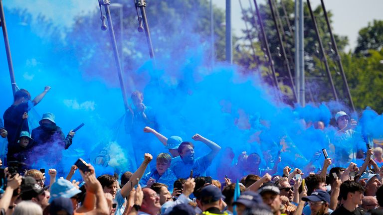 Supporters cheer outside Etihad Stadium