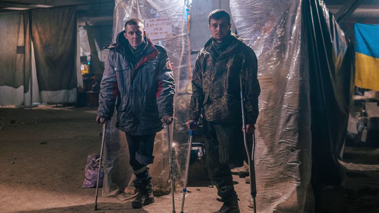 In this photo provided by the Azov Special Forces Regiment of the Ukrainian National Guard Press Office, Ukrainian soldiers wounded in battle against Russian forces pose for a photographer inside the steel plant in Azovstal in Mariupol, Ukraine, May 10, 2022. For nearly three months, the Azovstal garrison hung on, refusing to be driven out of the tunnels and bunkers beneath the labyrinthine mill ruins.  A Ukrainian soldier-photographer documented the events and broadcast them to the world.  NOW