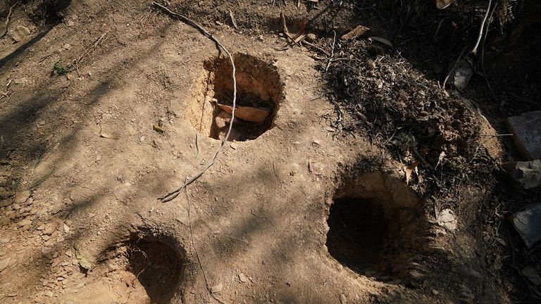 Holes dug apparently for soil samples in the area around the reservoir