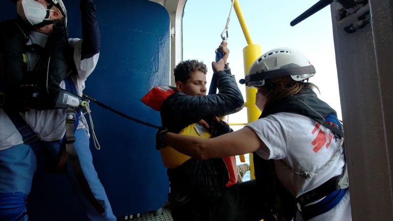 A young injured man is lifted on the Geo Barents with a sling as he was not able to climb the access ladder himself to embark on the ship.