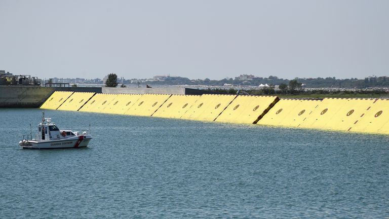 Yellow mobile barriers are seen above the surface of the water during tests of flood barrier project Experimental Electromechanical Module (Mose) in Venice, Italy, July 10, 2020. REUTERS/Flavio Lo Scalzo
