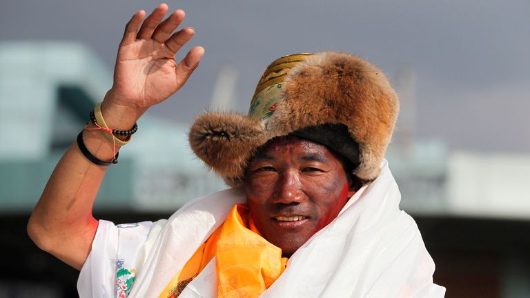 Nepalese veteran Sherpa guide Kami Rita waves as he arrives in Kathmandu in 2018. Pic: AP 