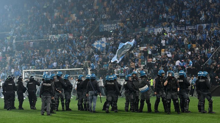 Police on the pitch after the match as Napoli fans celebrate winning the Serie A