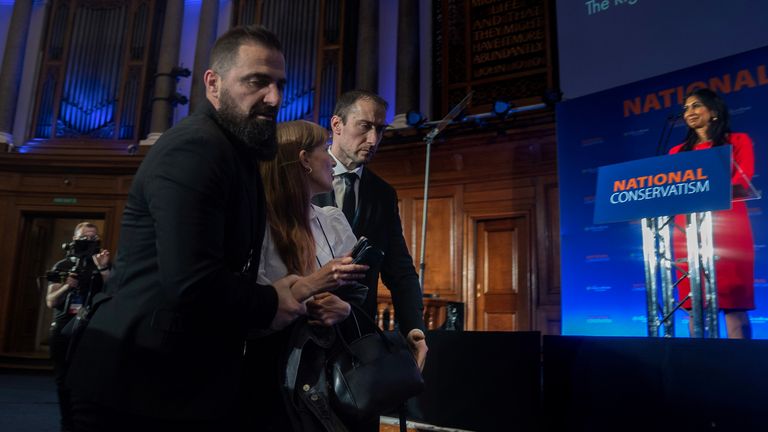 A protestor is removed from the audience during Home Secretary Suella Braverman&#39;s speech during the National Conservatism Conference at the Emmanuel Centre, central London. Picture date: Monday May 15, 2023.