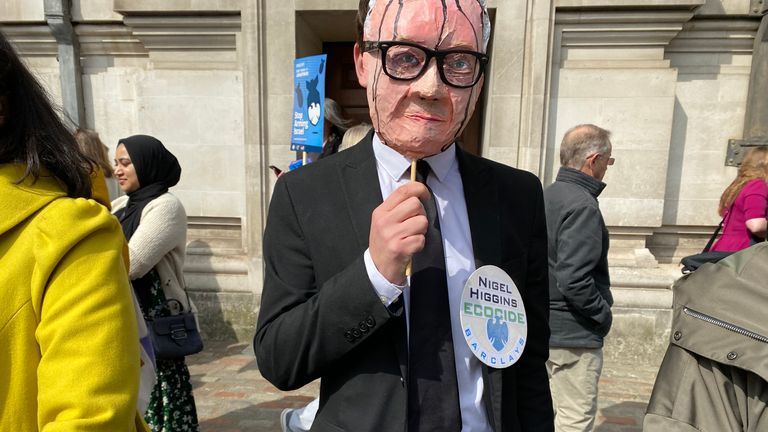 Climate activist dressed as Barclays group chairman Nigel Higgins