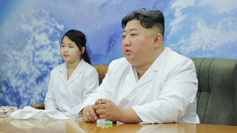 North Korean leader Kim Jong Un and his daughter Kim Ju Ae meet members of the Non-Permanent Satellite Launch Preparatory Committee, as he inspects the country's first military reconnaissance satellite, in Pyongyang, North Korea