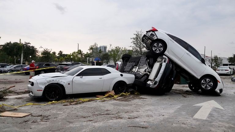 Damaged cars appear in a car park after a tornado hit the area 