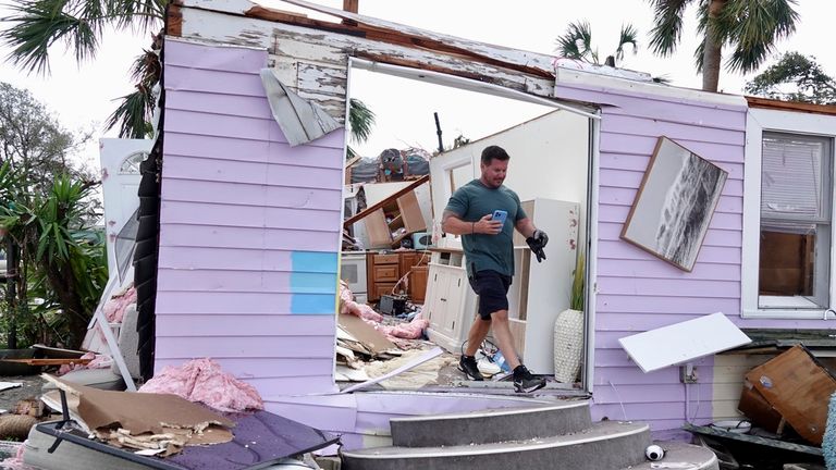 A man looks over the damage to his rented bungalow in Palm Beach