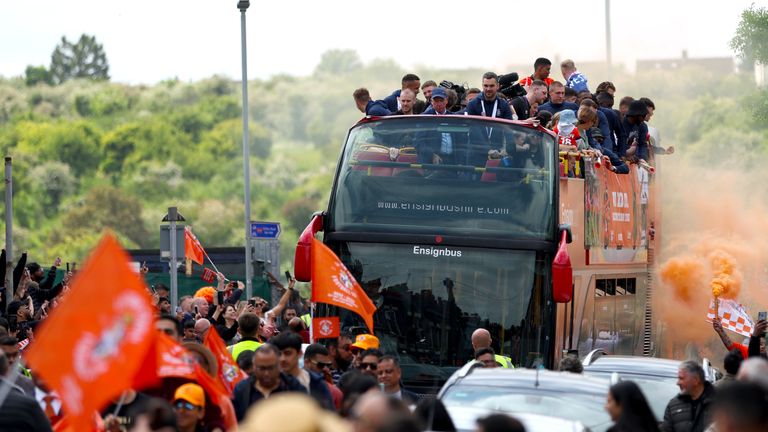 Luton Town players celebrate their promotion to the Premier League during an open top bus parade