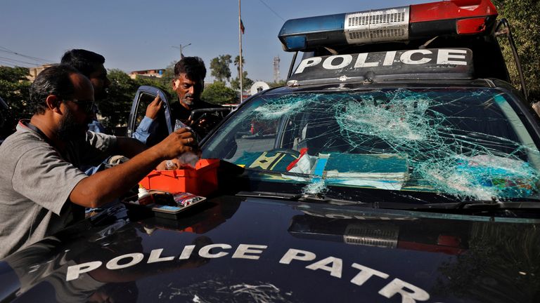 A police officer receives first aid after he was injured during a protest by the supporters of Pakistan&#39;s former Prime Minister Imran Khan after his arrest, in Karachi, Pakistan, May 9, 2023. REUTERS/Akhtar Soomro
