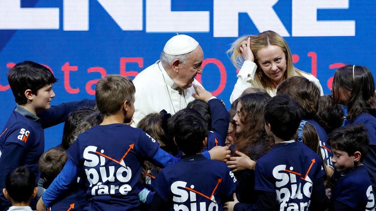 Pope Francis and Italy&#39;s Prime Minister Giorgia Meloni greet children at a national confront on demographics in Rome, Italy, May 12, 2023. REUTERS/Remo Casilli