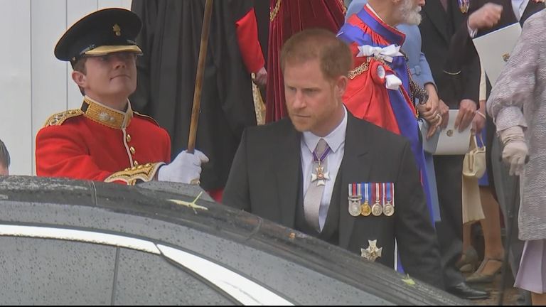 Prince Harry leaves the Abbey alone following the coronation