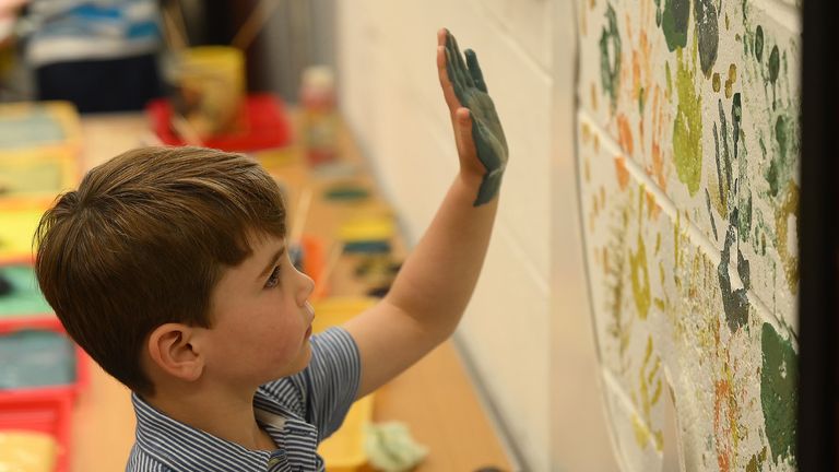 Prince Louis applies painted hand prints to the wall as he joins volunteers to help renovate and improve the 3rd Upton Scouts Hut in Slough, as part of the Big Help Out, to mark the crowning of King Charles III and Queen Camilla. Picture date: Monday May 8, 2023.