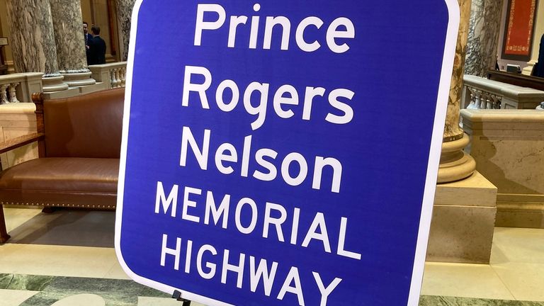 A replica sign stands outside the Minnesota Senate chambers, Thursday, May 4, 2023, in St. Paul, Minn., after the Senate voted to honor the late pop superstar Prince by designating the highway that runs past his Paisley Park museum and studios in Chanhassen, Minn., as the Prince Rogers Nelson Memorial Highway. The signs are expected to go up soon. (AP Photo/Steve Karnowski)