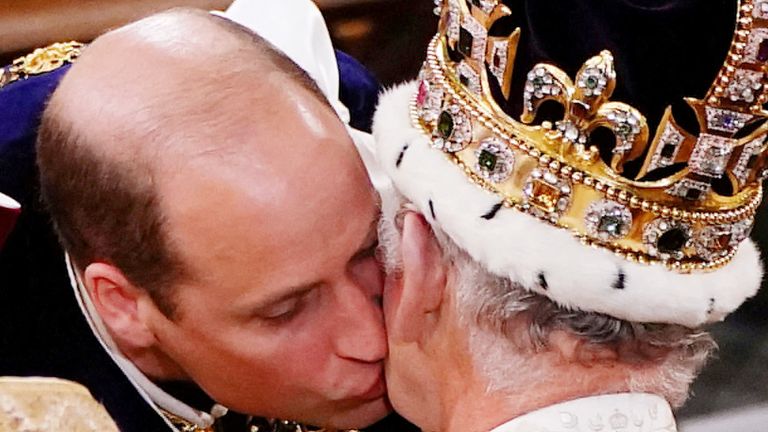 William, the Prince of Wales kisses his father King Charles III during his coronation ceremony 