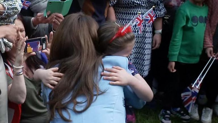 Princess of Wales comforts a little girl during Windsor walkabout