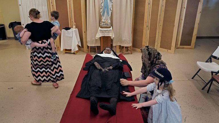 People pray over the body of Sister Wilhelmina Lancaster at the Benedictines of Mary, Queen of Apostles  
Pic:AP